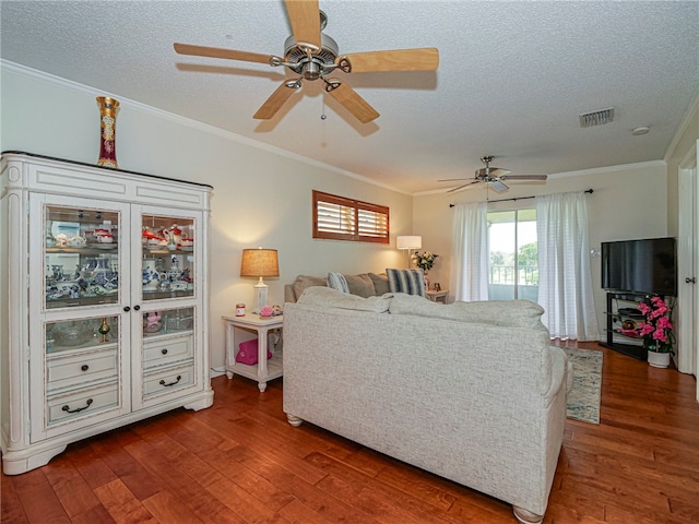 living room with a textured ceiling, dark hardwood / wood-style floors, ceiling fan, and crown molding