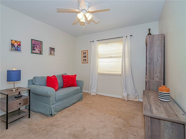 sitting room featuring ceiling fan and light colored carpet