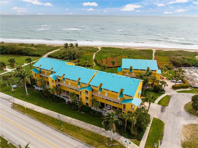 drone / aerial view featuring a beach view and a water view