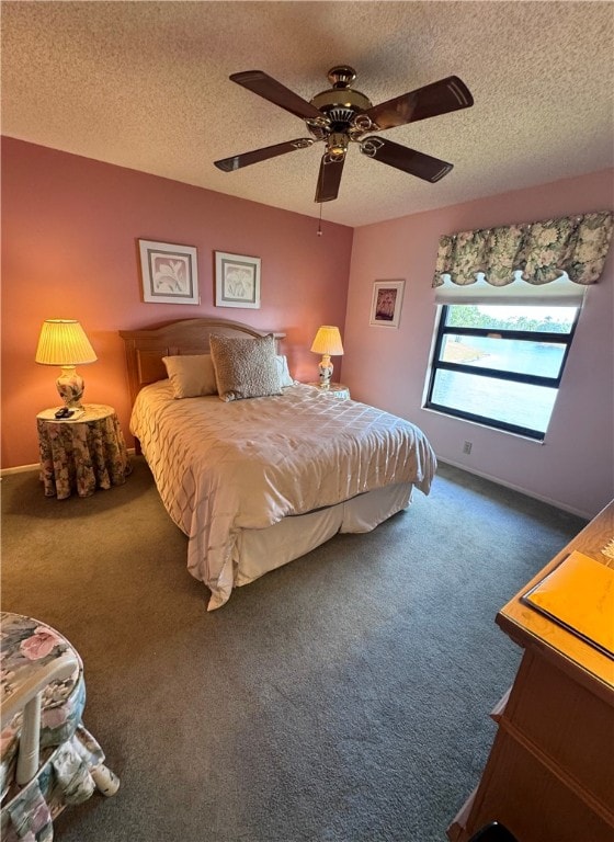 carpeted bedroom with a textured ceiling and ceiling fan