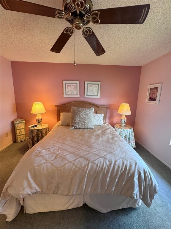 bedroom with ceiling fan, carpet, and a textured ceiling