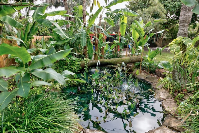 view of landscape featuring a garden pond