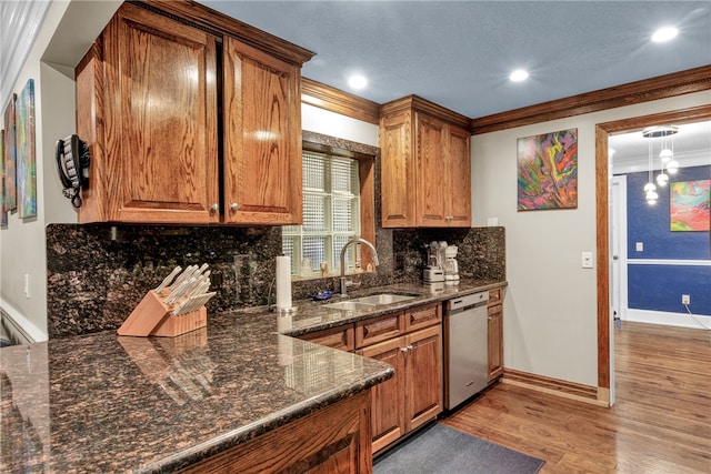 kitchen with tasteful backsplash, crown molding, light wood-type flooring, sink, and stainless steel dishwasher