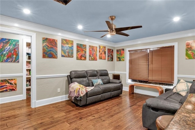 living room featuring wood-type flooring, ceiling fan, and crown molding