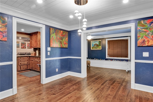 unfurnished dining area featuring ornamental molding and dark wood-type flooring