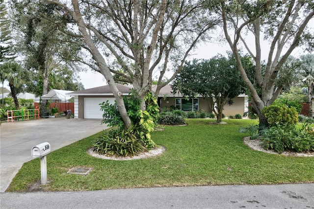 ranch-style home with a garage and a front yard