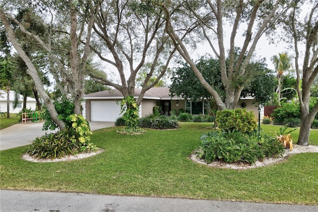 ranch-style home with a garage and a front lawn