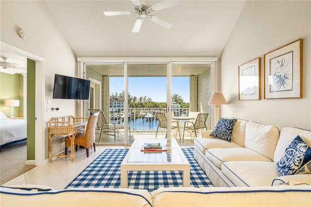 living room featuring ceiling fan, light tile patterned floors, and lofted ceiling