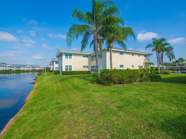 655 W Lake Jasmine Cir Unit 203, Vero Beach, FL 32962 - rear view of house featuring a yard and stucco siding