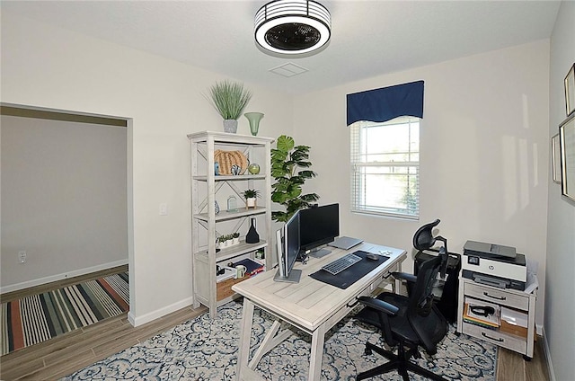 office area with wood finished floors and baseboards