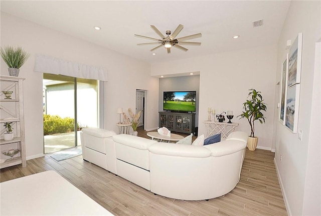 living room with light wood-type flooring, baseboards, visible vents, and recessed lighting