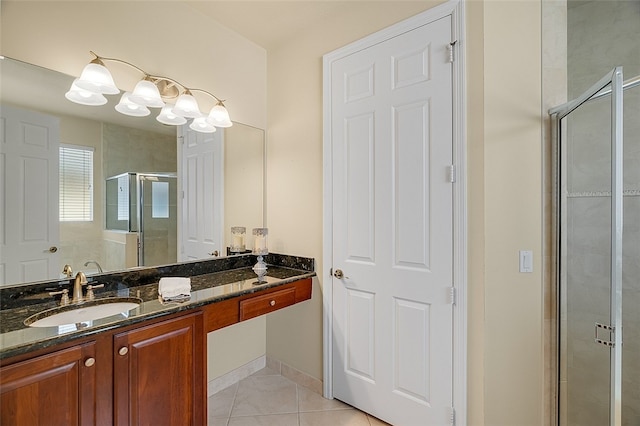 bathroom featuring an enclosed shower, vanity, and tile patterned floors