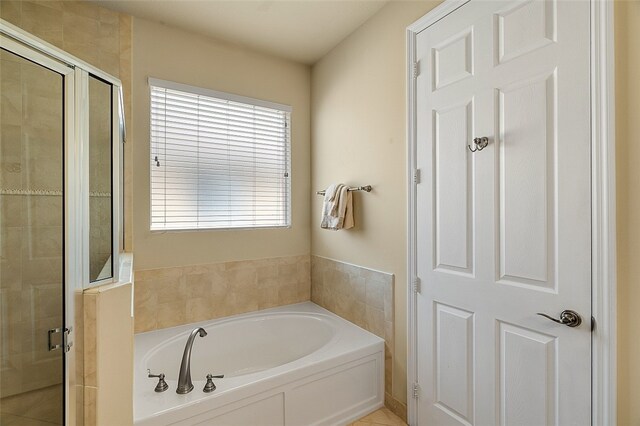 bathroom with separate shower and tub