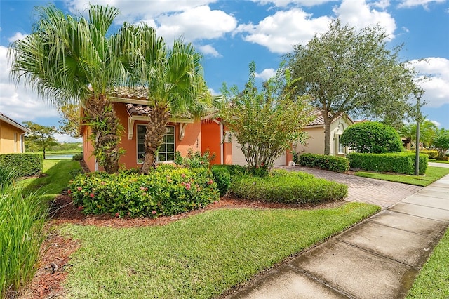 mediterranean / spanish-style house featuring a front yard