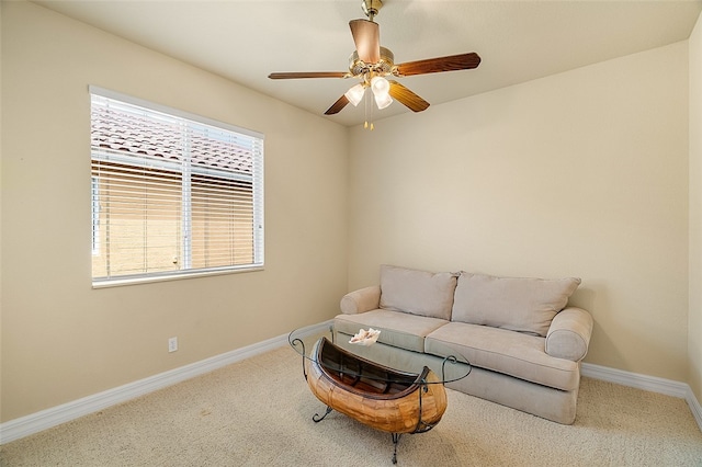 living area with carpet and ceiling fan