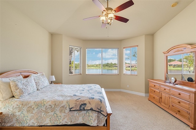 bedroom with light carpet, multiple windows, and ceiling fan