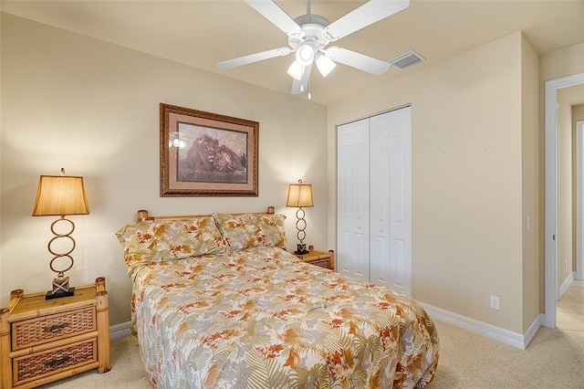 bedroom featuring a closet, light carpet, and ceiling fan