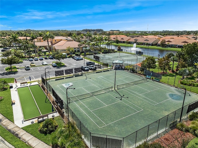 view of sport court with a water view