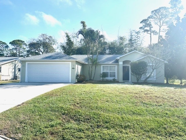 single story home with a garage and a front lawn