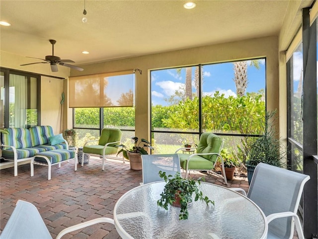 5205 Turtle Creek Cir, Vero Beach, FL 32967 - sunroom featuring brick floors, outdoor dining space, a ceiling fan, outdoor lounge area, and recessed lighting