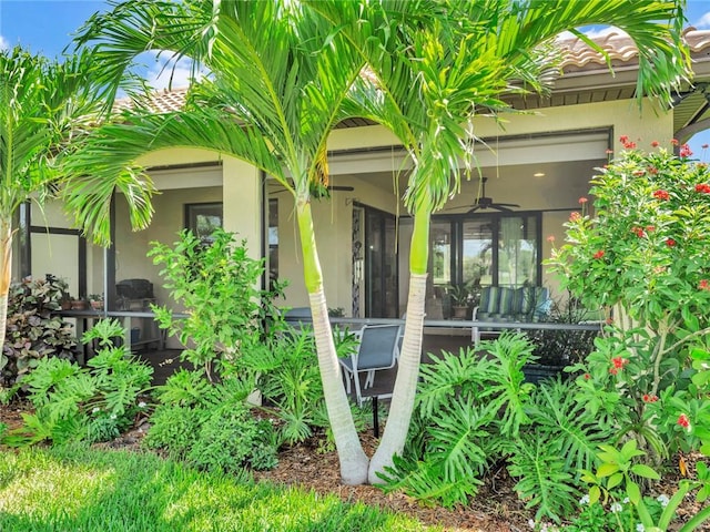 5205 Turtle Creek Cir, Vero Beach, FL 32967 - view of exterior entry with stucco siding and a ceiling fan