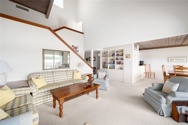 carpeted living room featuring wooden ceiling and built in shelves