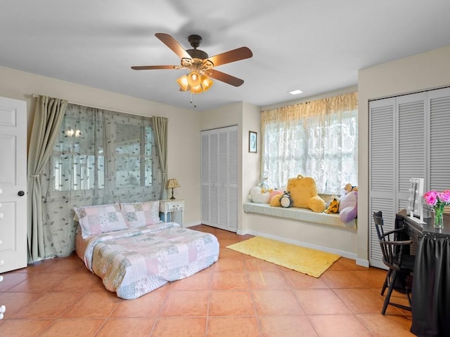 2237 10th Ave, Vero Beach, FL 32960 - tiled bedroom featuring two closets, ceiling fan, and baseboards