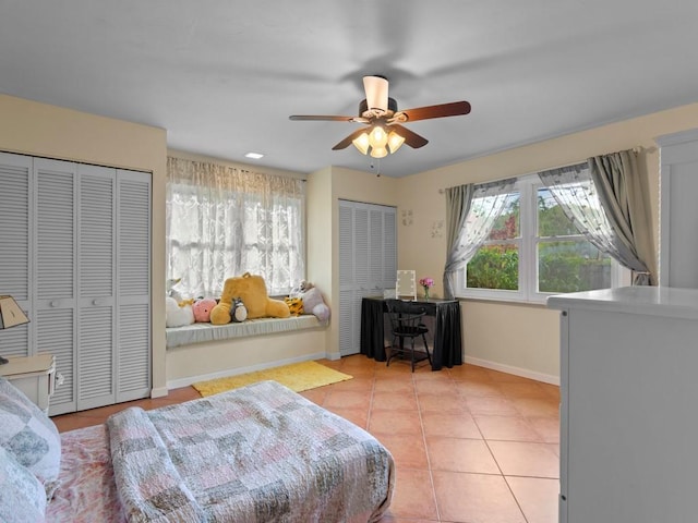 2237 10th Ave, Vero Beach, FL 32960 - bedroom with two closets, a ceiling fan, baseboards, and light tile patterned floors