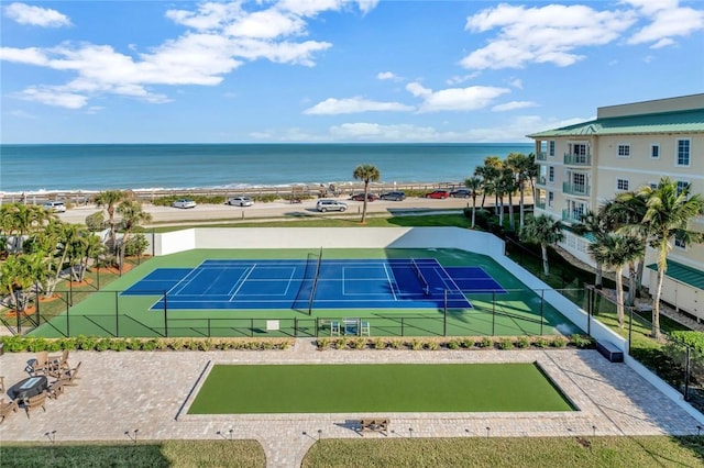 view of sport court with a water view