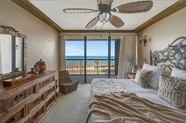 bedroom featuring a water view, ceiling fan, access to exterior, ornamental molding, and carpet floors