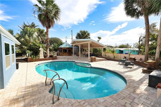 view of pool with a gazebo, a patio area, and an in ground hot tub