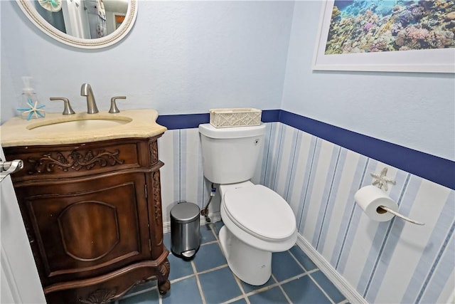 bathroom featuring vanity, toilet, and tile patterned flooring