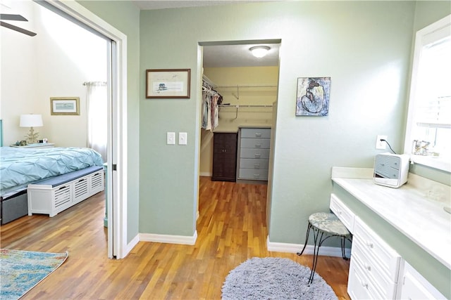 bathroom with ceiling fan and wood-type flooring