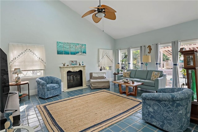 tiled living room with ceiling fan and high vaulted ceiling