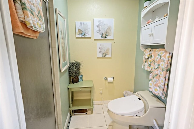 bathroom with a shower with door, tile patterned floors, and toilet