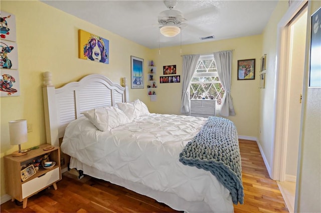 bedroom featuring hardwood / wood-style flooring and ceiling fan