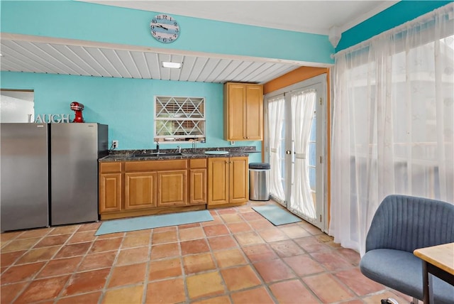 kitchen with sink, light tile patterned floors, and stainless steel refrigerator