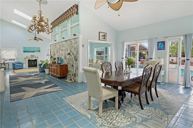 dining area with ceiling fan with notable chandelier and high vaulted ceiling