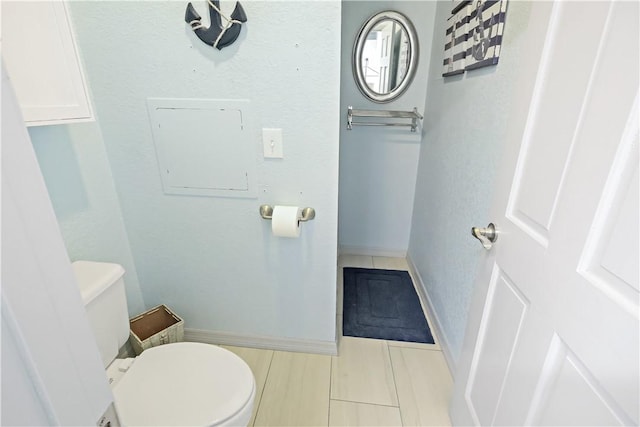 bathroom with electric panel and toilet