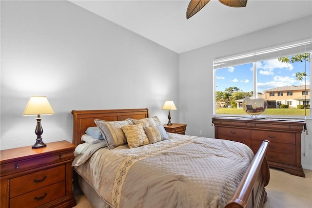 bedroom with lofted ceiling, light carpet, and ceiling fan