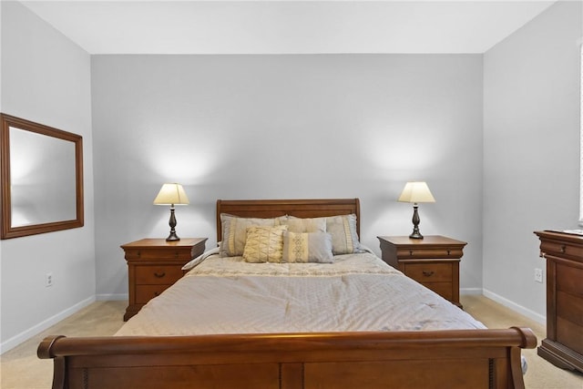 bedroom featuring baseboards and light colored carpet