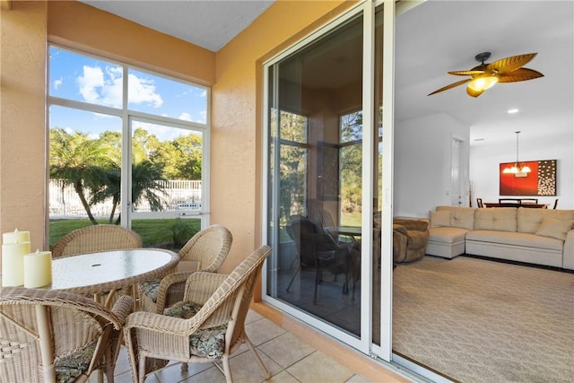 sunroom with a ceiling fan