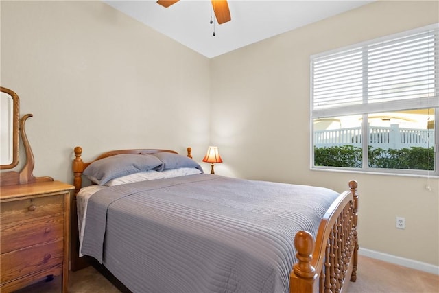 carpeted bedroom featuring baseboards and a ceiling fan