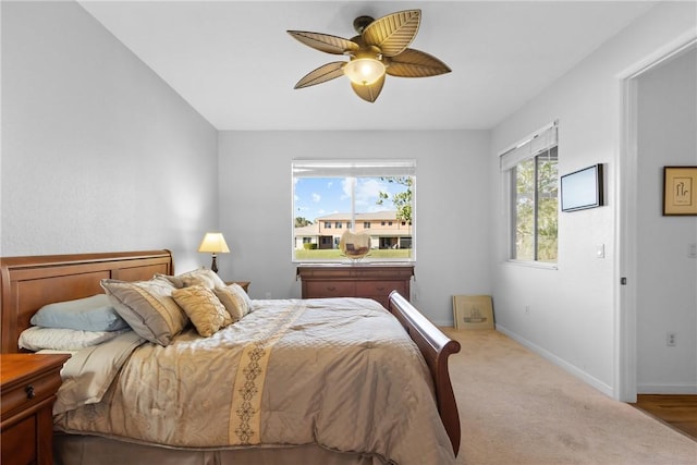 bedroom with a ceiling fan, carpet, and baseboards