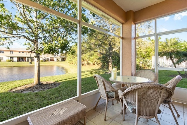 sunroom with a water view and a healthy amount of sunlight