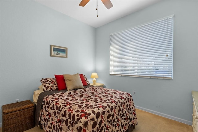 carpeted bedroom featuring a ceiling fan and baseboards