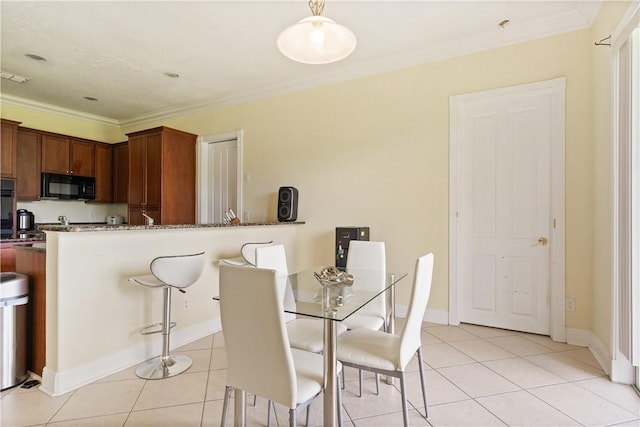6139 57th Ct, Vero Beach, FL 32967 - dining area featuring light tile patterned floors, crown molding, and baseboards