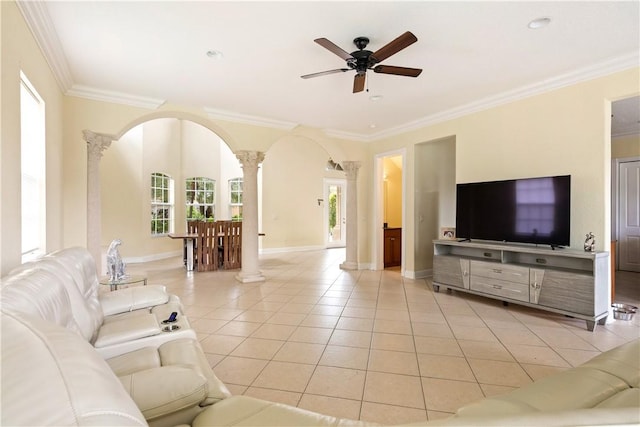 6139 57th Ct, Vero Beach, FL 32967 - living room featuring decorative columns, ceiling fan, light tile patterned floors, arched walkways, and ornamental molding