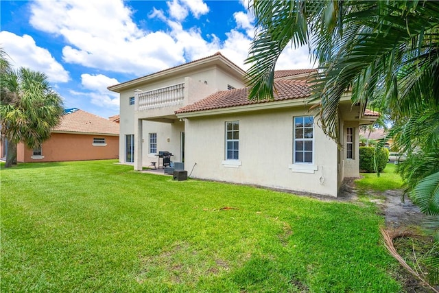 6139 57th Ct, Vero Beach, FL 32967 - rear view of house with stucco siding, a yard, a tiled roof, and a patio