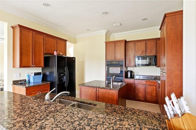 6139 57th Ct, Vero Beach, FL 32967 - kitchen with a sink, black appliances, a center island with sink, ornamental molding, and dark stone countertops